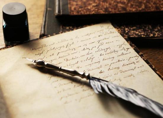 An image of a quill, ink bottle and book
